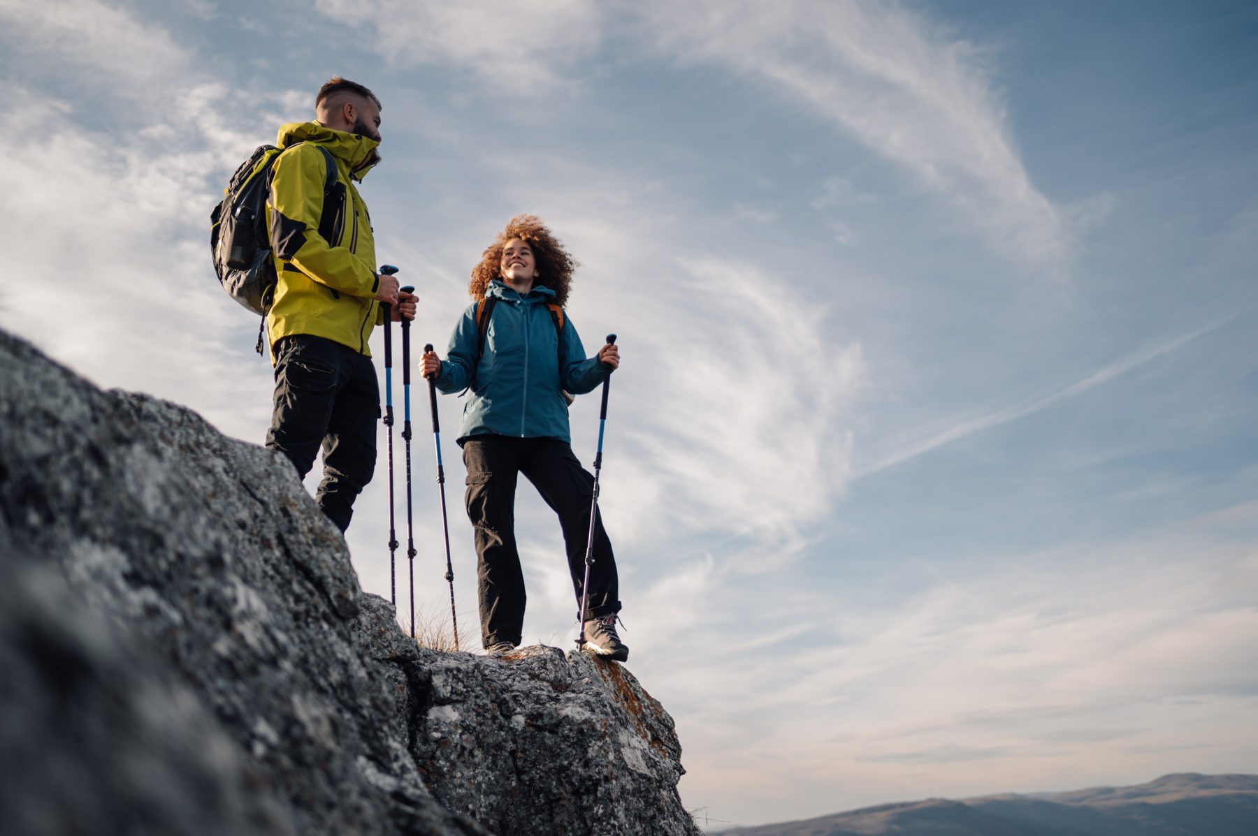 Two hikers with trekking poles
