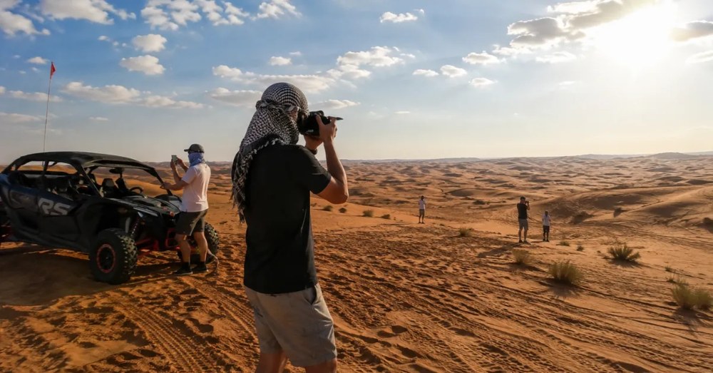 A photographer filming in the dunes