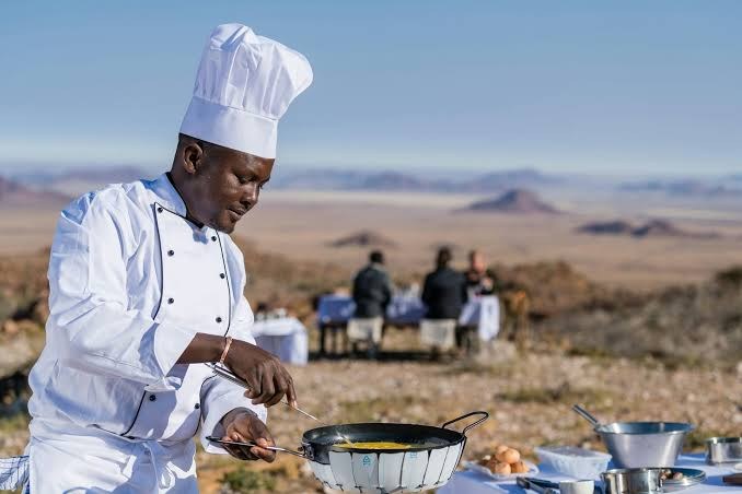 A chef cooking in the desert